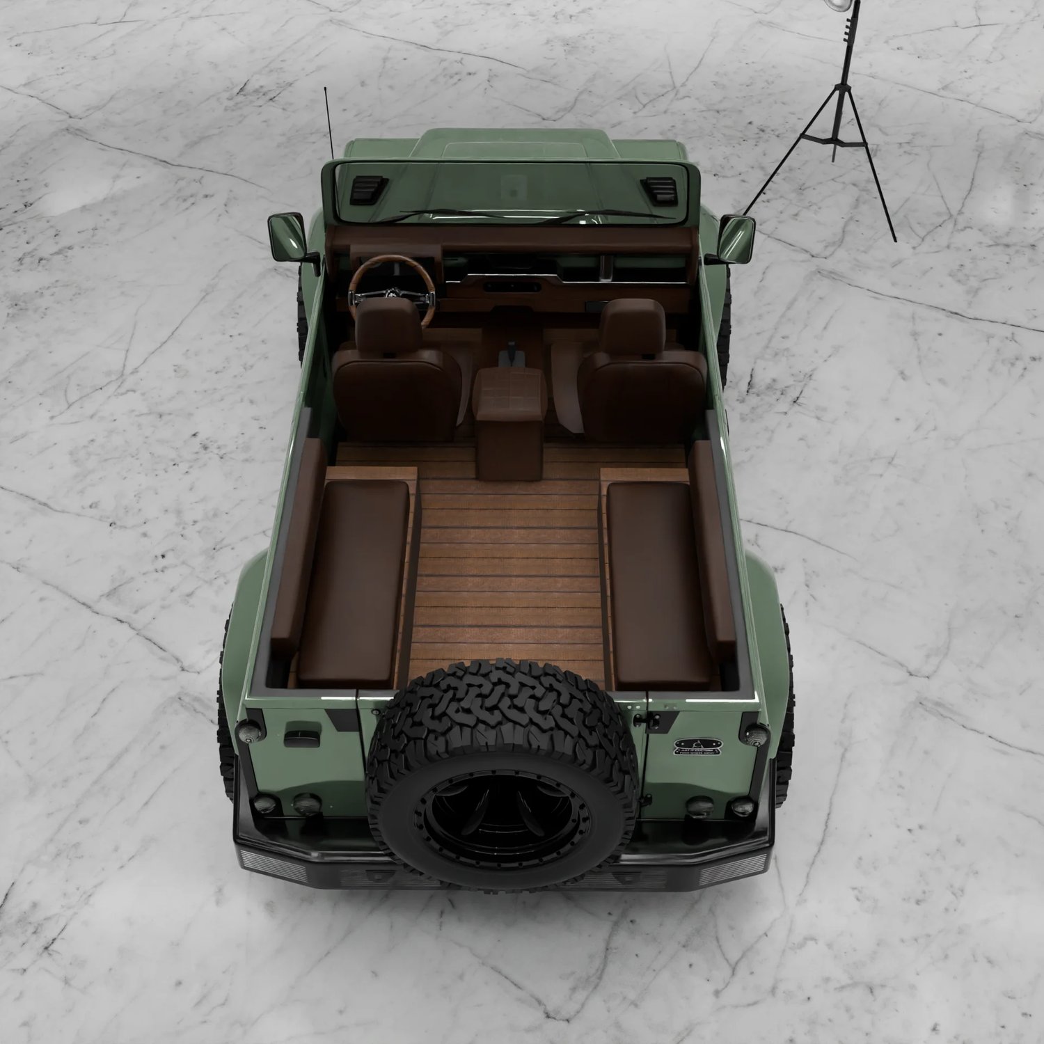 Intérieur Classic Defender — plancher bois et banquettes cuir, configuration ouverte